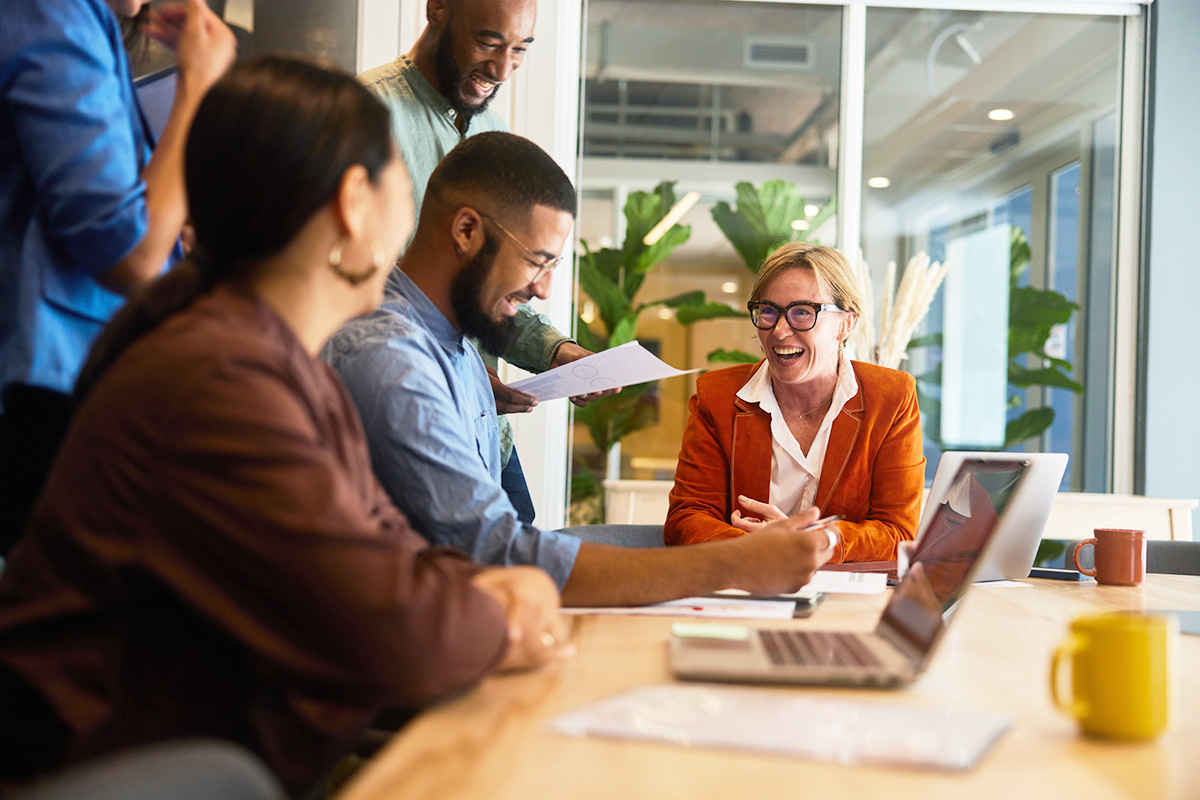 Groupe de personnes riant dans un bureau